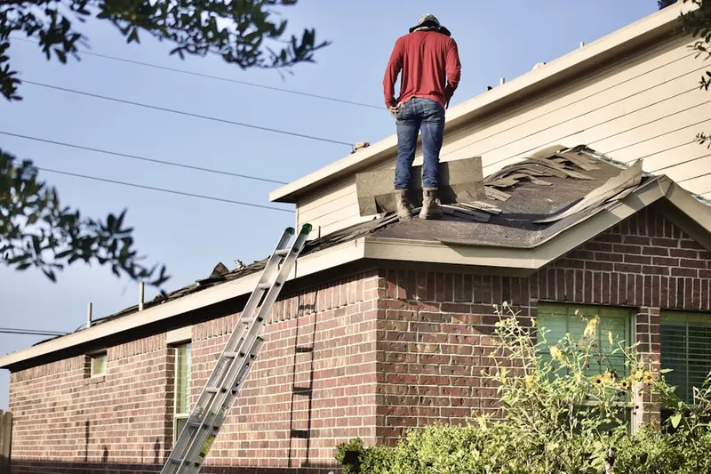 Professional roofer working on a residential roof in Van Ness